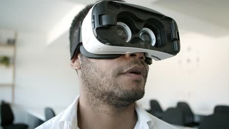 Smiling-African-American-man-experiencing-new-VR-glasses